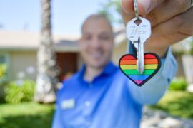 realtor with key and heart keychain - how to find a green real estate agent