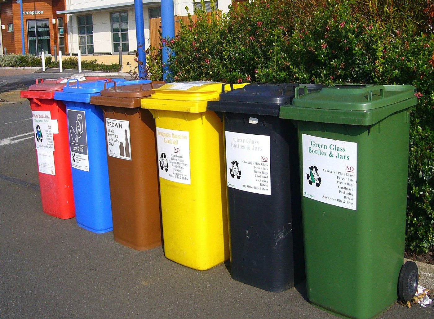 Six recycle bins in front of building - Construction recycling