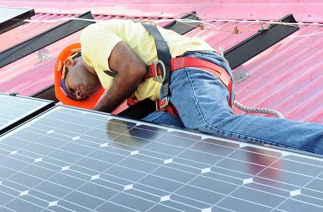 Installing solar panels on a house roof