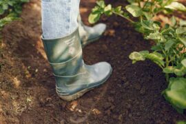 gardener in rain boots - reasons to weed your garden naturally