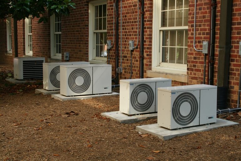 Air conditioning units outside row of homes. Photo from Pixabay.