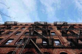 apartment building with air conditioners - mistakes that shorten the life of your air conditioner