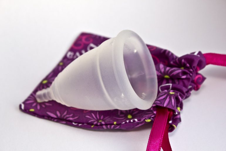 Menstrual cup next to fabric holder. Photo from menstruationstasse.net via Flickr.