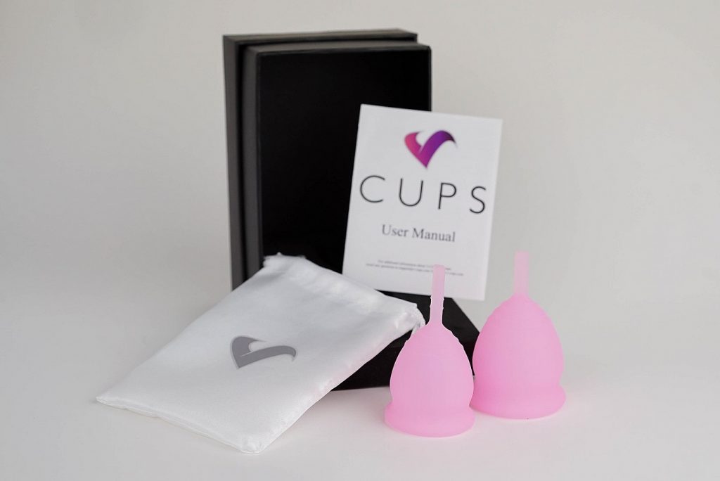 Two V-cup menstrual cups next to user's manual. Photo from Wikimedia Commons.