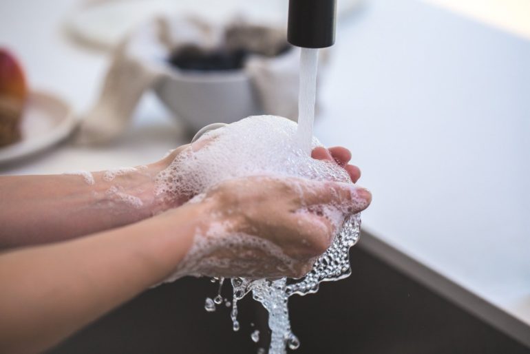 person washing hands - best safe and non-toxic dish soap guide