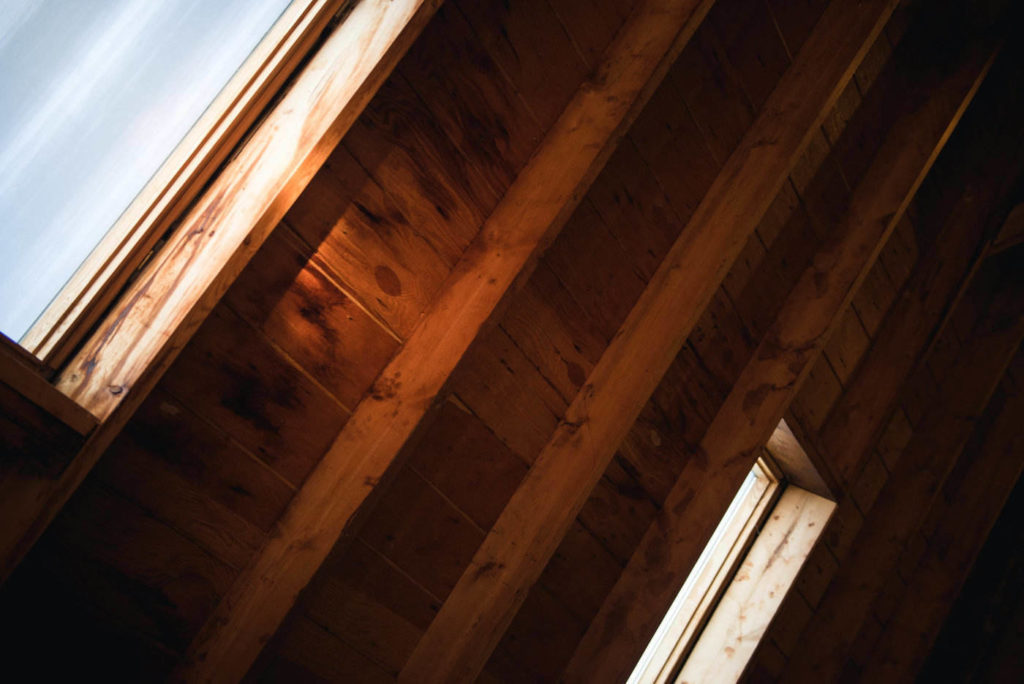 attic rafters and windows - blown-in attic insulation