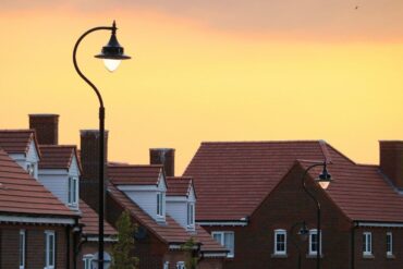 rooftops under streetlight at sunset - how do i make my home more energy efficient