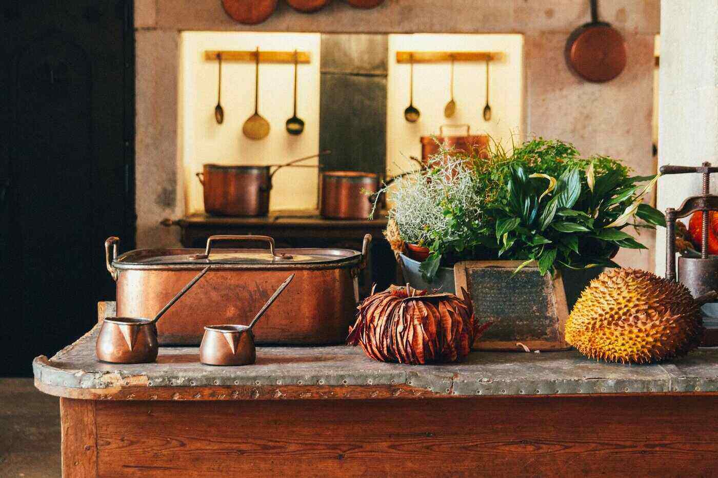 copper pots and pans in kitchen - tips for choosing eco-friendly cookware
