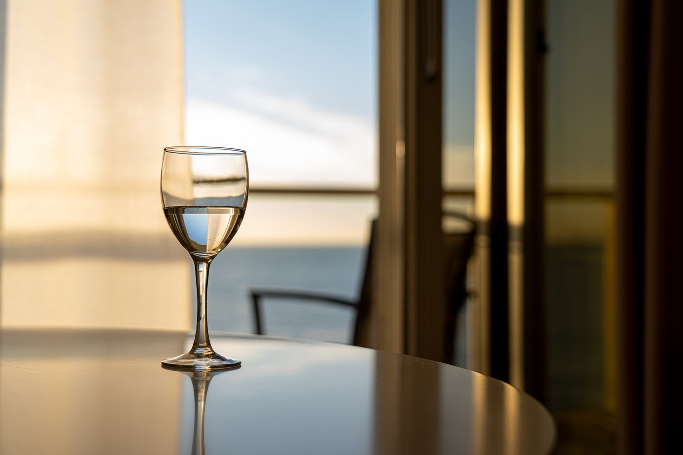 water in wine glass on dining table - how to live green on the go