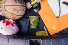 car trunk with garbage and sports equipment - minimize household waste