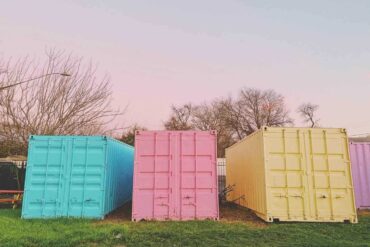 pastel shipping containers on grass - how to make the most of your space in a shipping container home