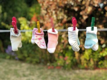 baby socks on clothesline - 8 tips for a sustainable household