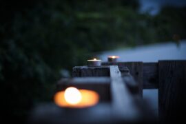 tealight candles burning on fence - best non toxic environmentally friendly candles
