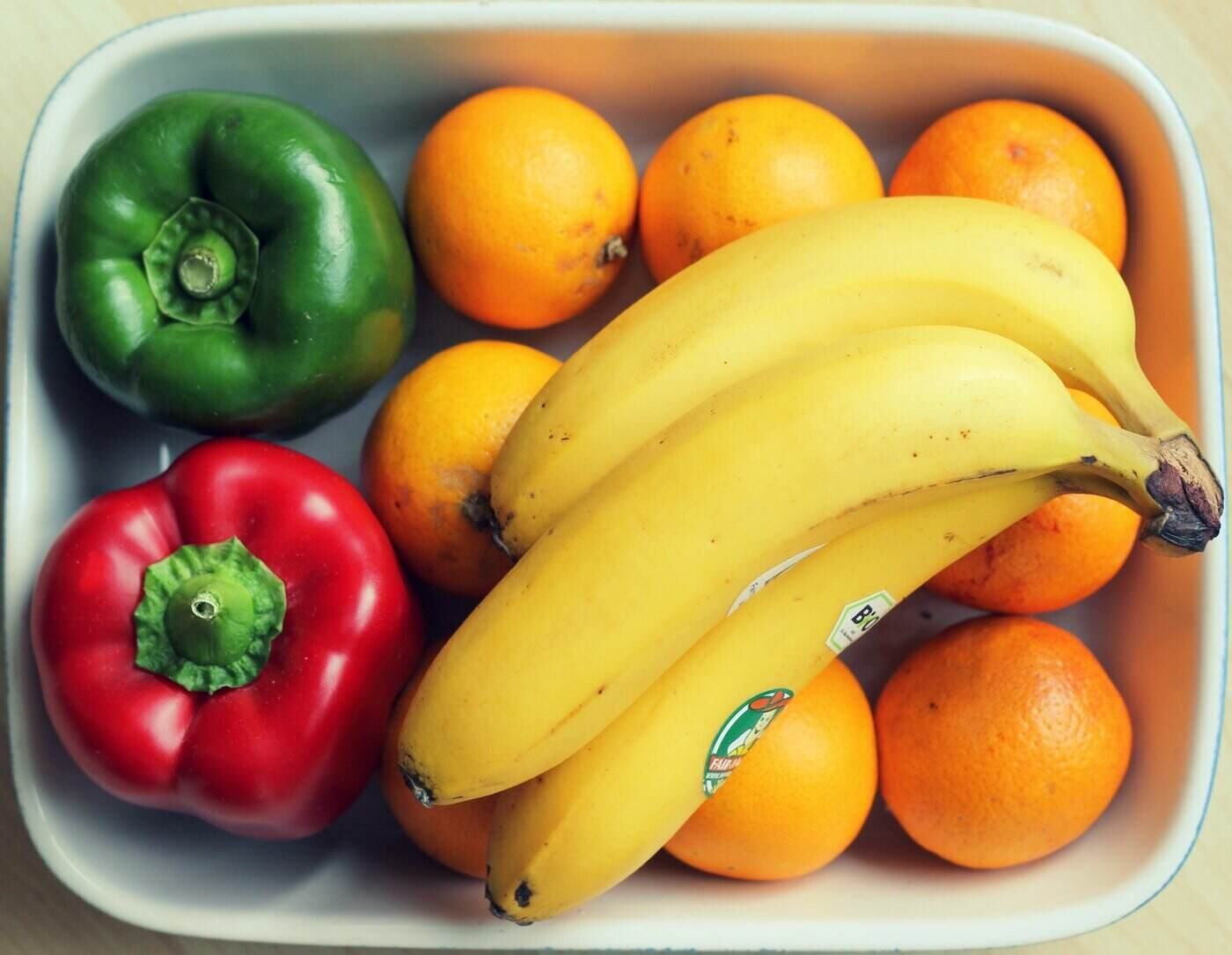 bananas oranges and peppers in dish - 5 ways reducing food waste can help save the environment