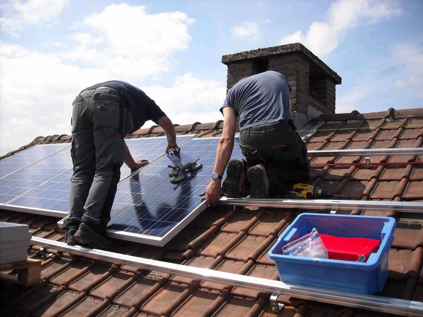 two men installing solar panels on roof - what equipment do you need to diy a solar system