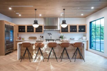 renovated kitchen with island and barstools - create a dream kitchen entirely from reclaimed materials