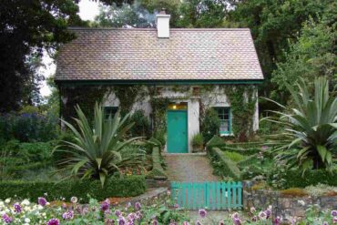 tiny house with garden and green garden gate - tiny house plans