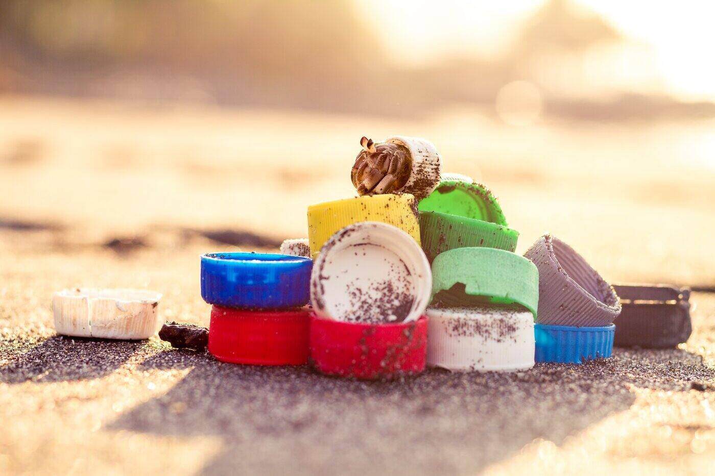 pile of plastic bottle caps on beach - a guide to greenwashing and how to avoid it