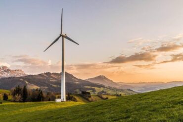 wind turbine by hills - energy transition europe - how homes can help the eu get off fossil fuels