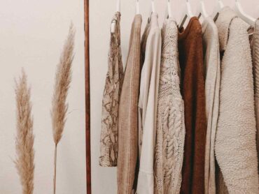 beige clothes on hangers - tips for making your wardrobe more sustainable